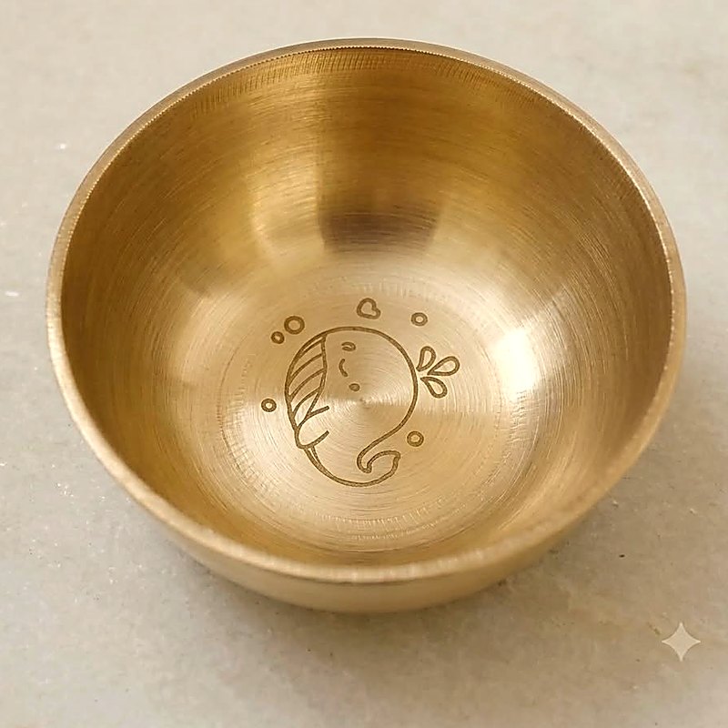 Close-up of the whale engraved into the base of the bronze katori bowl