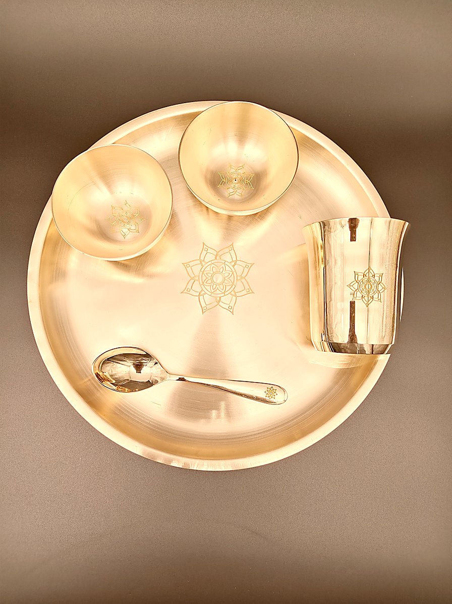 Tuoom kansa dinner set from above — bronze thali with two katoris, a tumbler and a spoon
