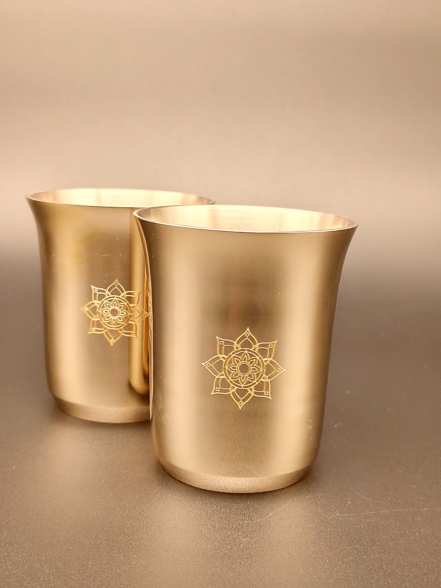 Two Tuoom kansa bronze tumblers standing side by side