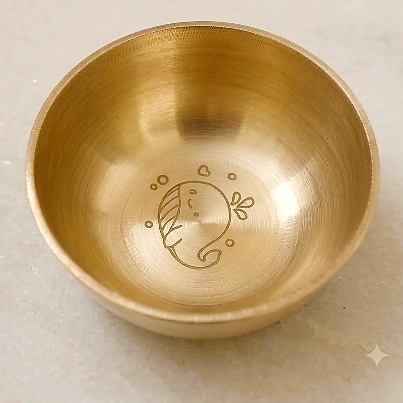 Close-up of the whale engraved into the base of the bronze katori bowl